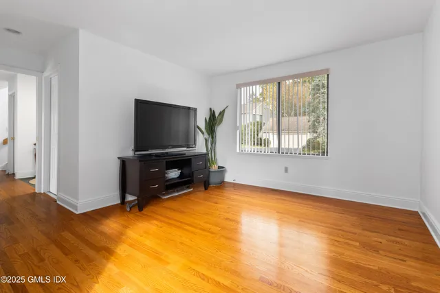 a living room with a flat screen tv and a window
