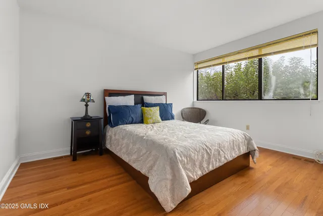 a bedroom with a bed and window