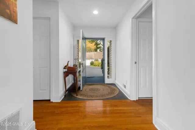 a view of a livingroom with tub and mirror
