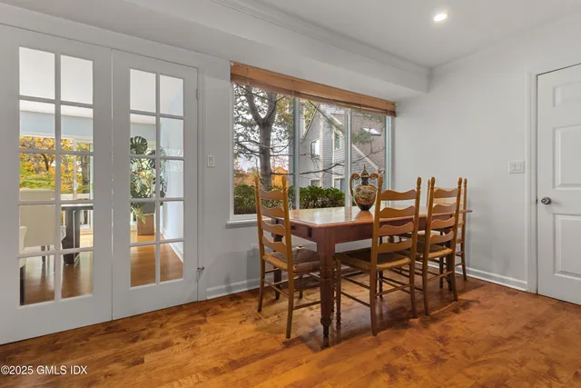 a view of a dining room with furniture large windows and wooden floor