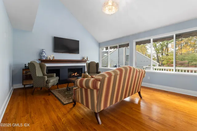 a living room with furniture fireplace and flat screen tv