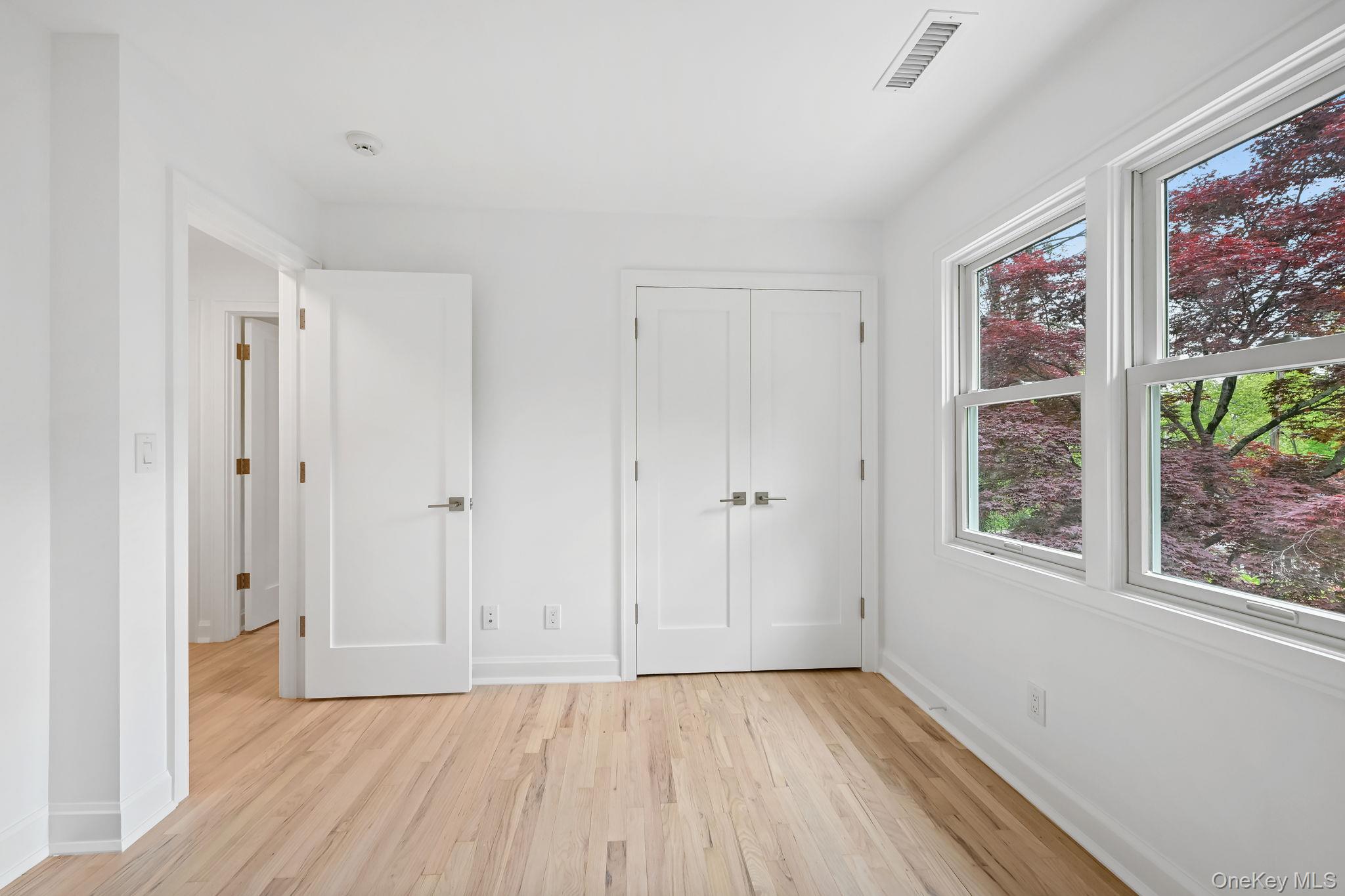 24 Country Road Mamaroneck, NY 10543 - Photo 22 of 37 a view of an empty room with window and wooden floor