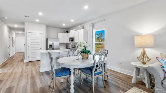a view of a dining room with furniture and wooden floor