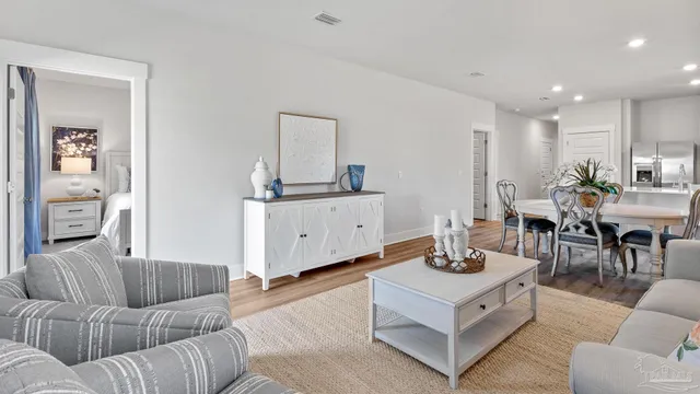 a living room with furniture and view of kitchen