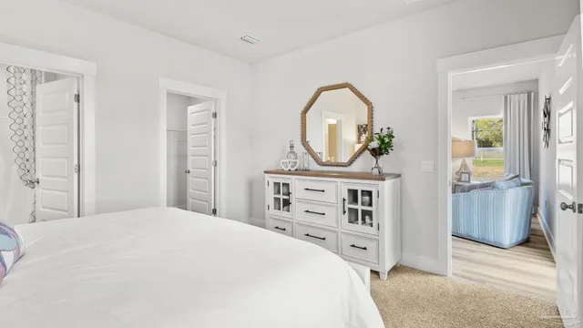 a bedroom with a bed and a dresser