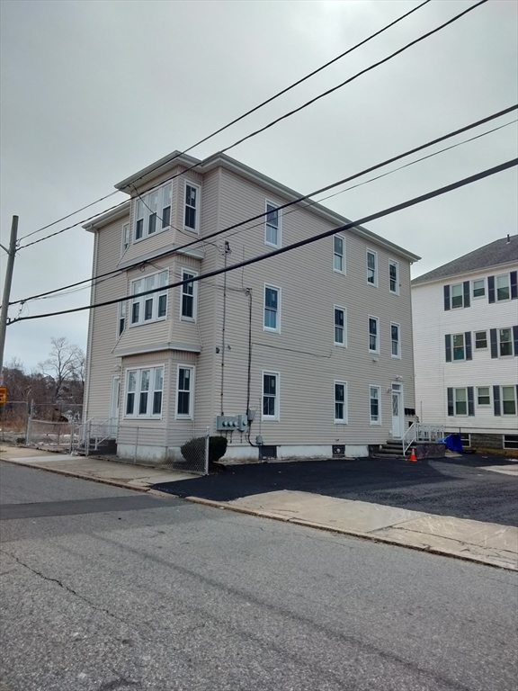 269 Brightman Street, Unit 2 Fall River, MA 02720 - Photo 1 of 12 a street view with tall buildings and a street sign