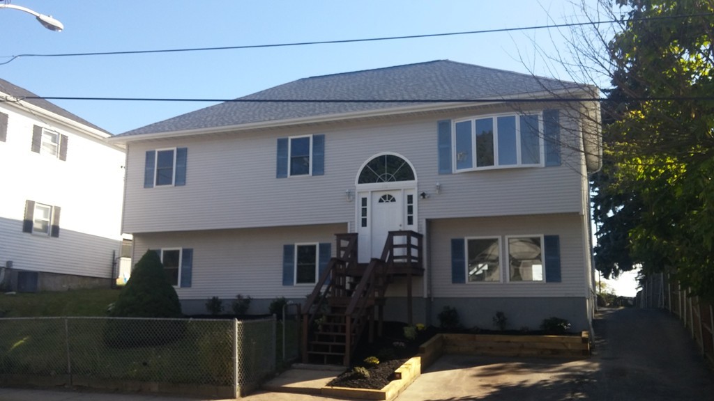 1323 Slade Street Fall River, MA 02721 - Photo 1 of 12 a front view of a house with yard
