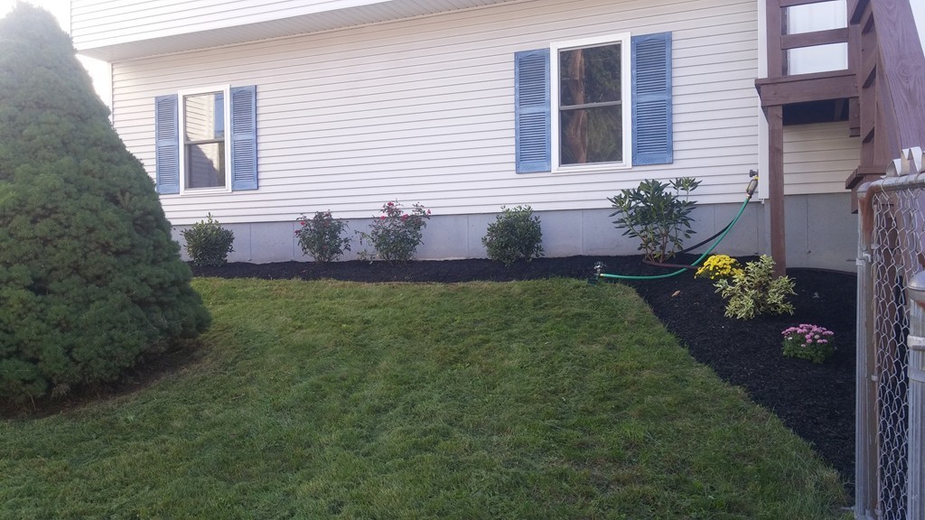 1323 Slade Street Fall River, MA 02721 - Photo 4 of 12 a front view of a house with garden