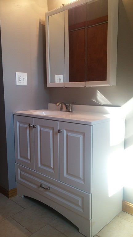 1323 Slade Street Fall River, MA 02721 - Photo 7 of 12 a bathroom with a sink and a mirror