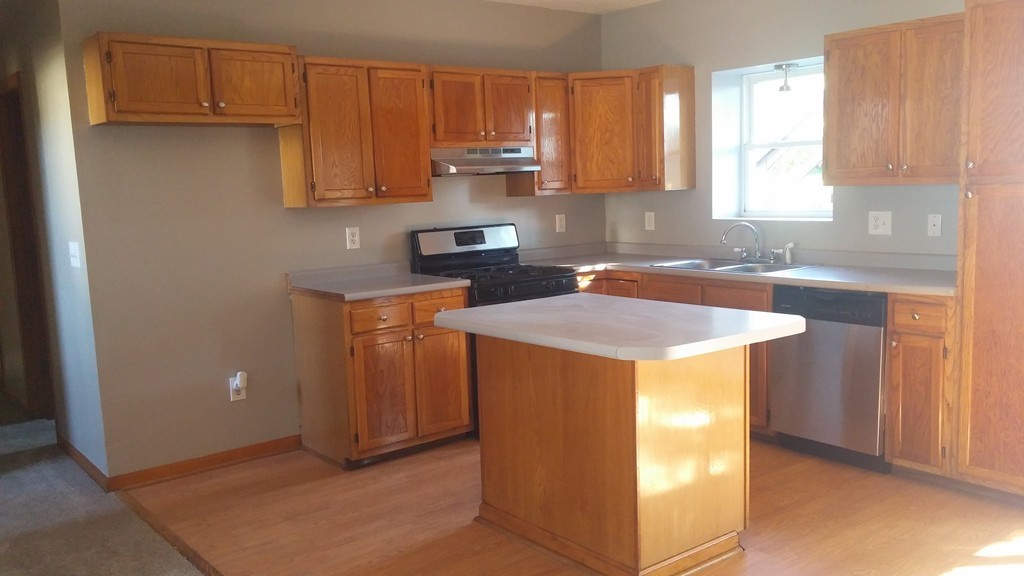 1323 Slade Street Fall River, MA 02721 - Photo 9 of 12 a kitchen with stainless steel appliances granite countertop a sink stove and refrigerator