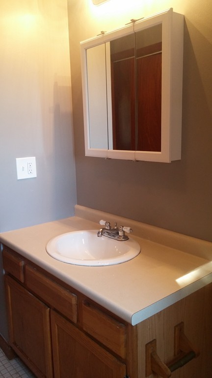 1323 Slade Street Fall River, MA 02721 - Photo 10 of 12 a bathroom with a sink and a mirror