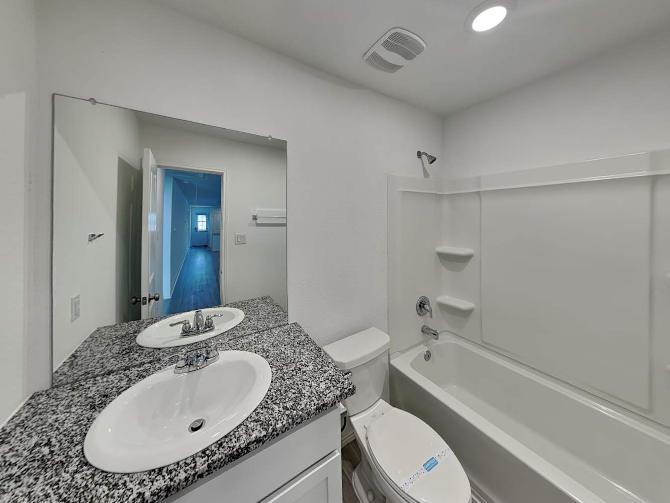 4133 Waterfall Cove San Antonio, TX 78223 - Photo 11 of 12 a bathroom with a granite countertop sink a toilet and shower
