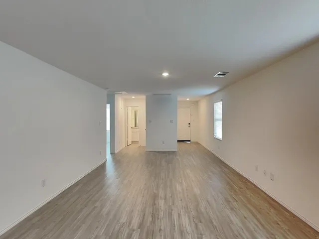 a view of a livingroom with wooden floor and a window