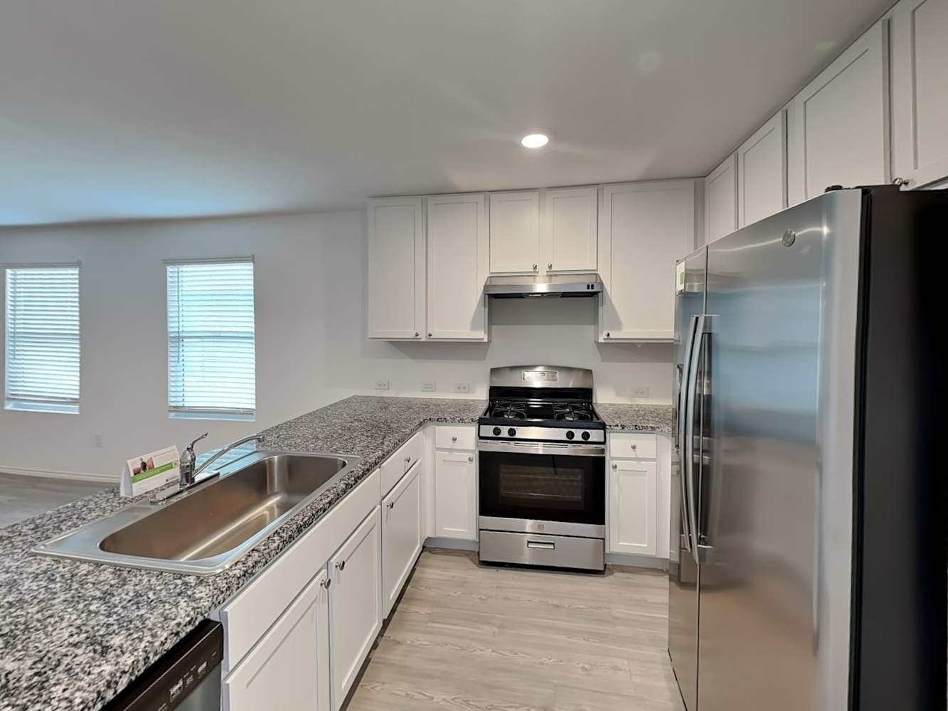 4133 Waterfall Cove San Antonio, TX 78223 - Photo 6 of 12 a kitchen with granite countertop a sink stove and refrigerator