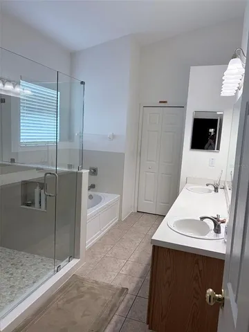 a spacious bathroom with a tub and a shower