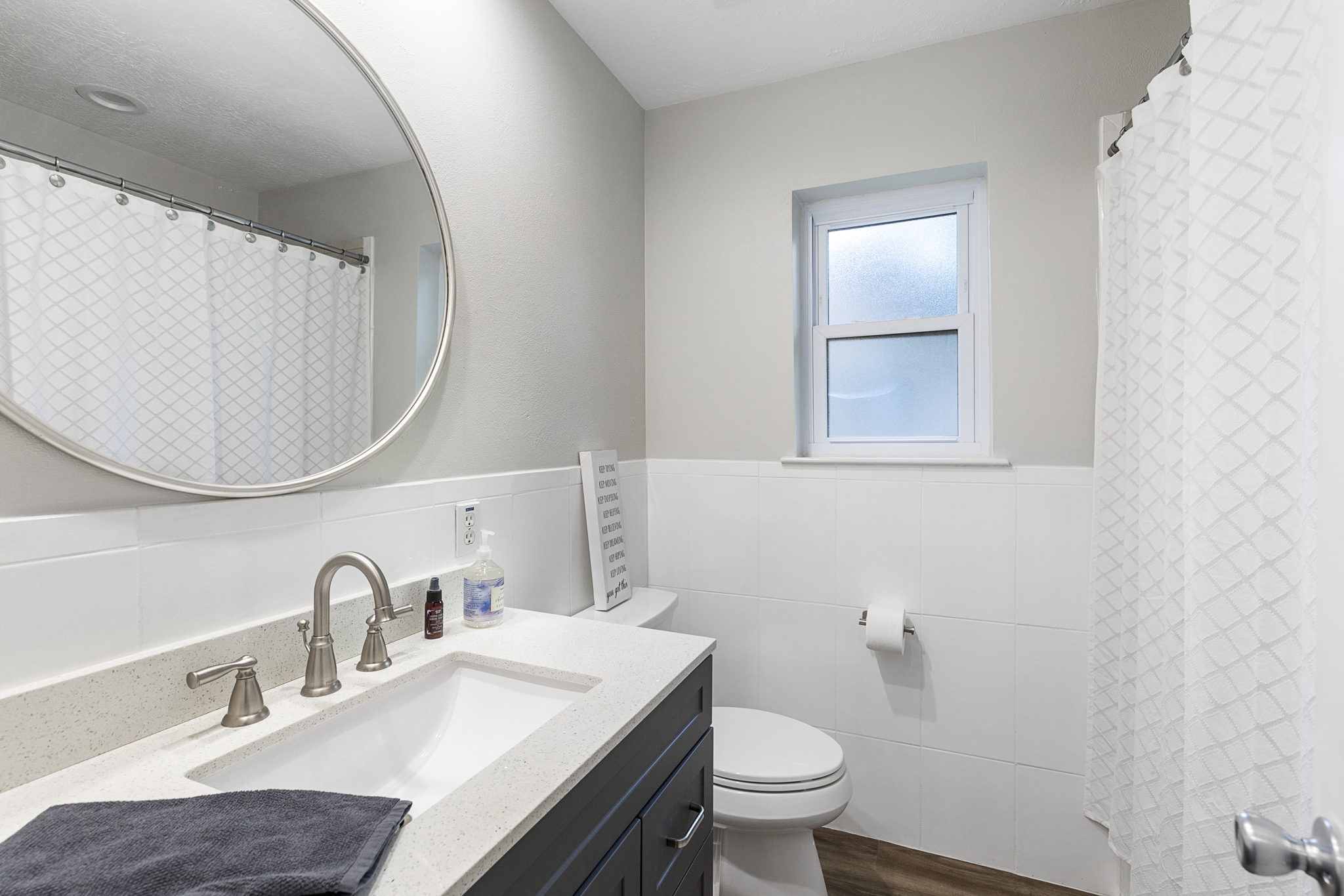 623 Hickory Ridge Drive Shenandoah, TX 77381 - Photo 23 of 26 a bathroom with a toilet a sink a mirror and vanity