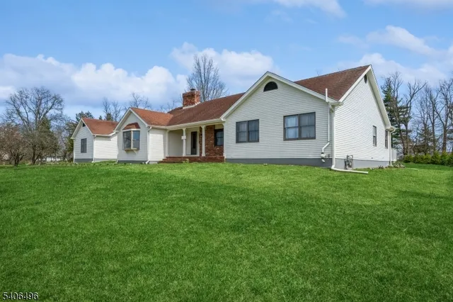 a view of house with yard and green space