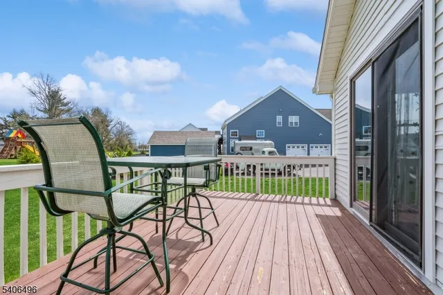 a view of a balcony with chairs and wooden floor