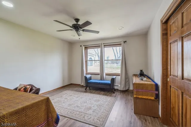 a room with a bed and wooden floor