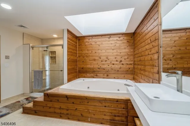 a bathroom with a bathtub and shower