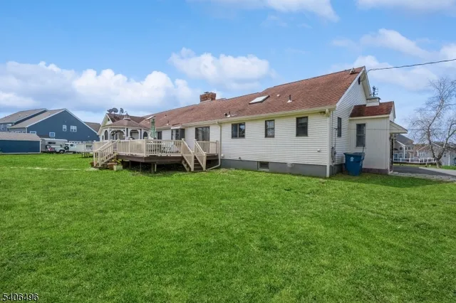 a view of a house with a backyard and plants