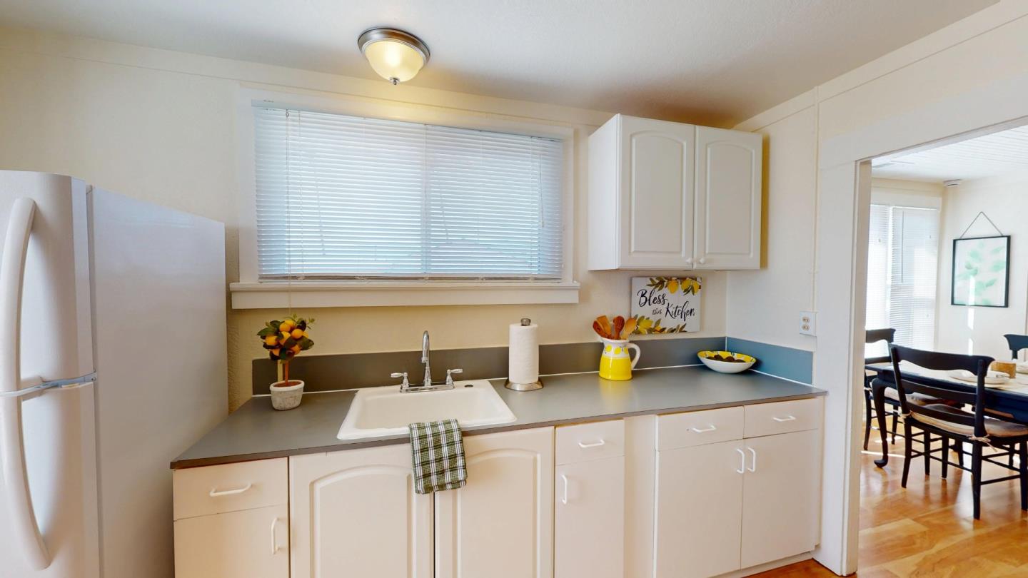 236 West Street Soledad, CA 93960 - Photo 15 of 41 a kitchen with a sink a stove and white cabinets