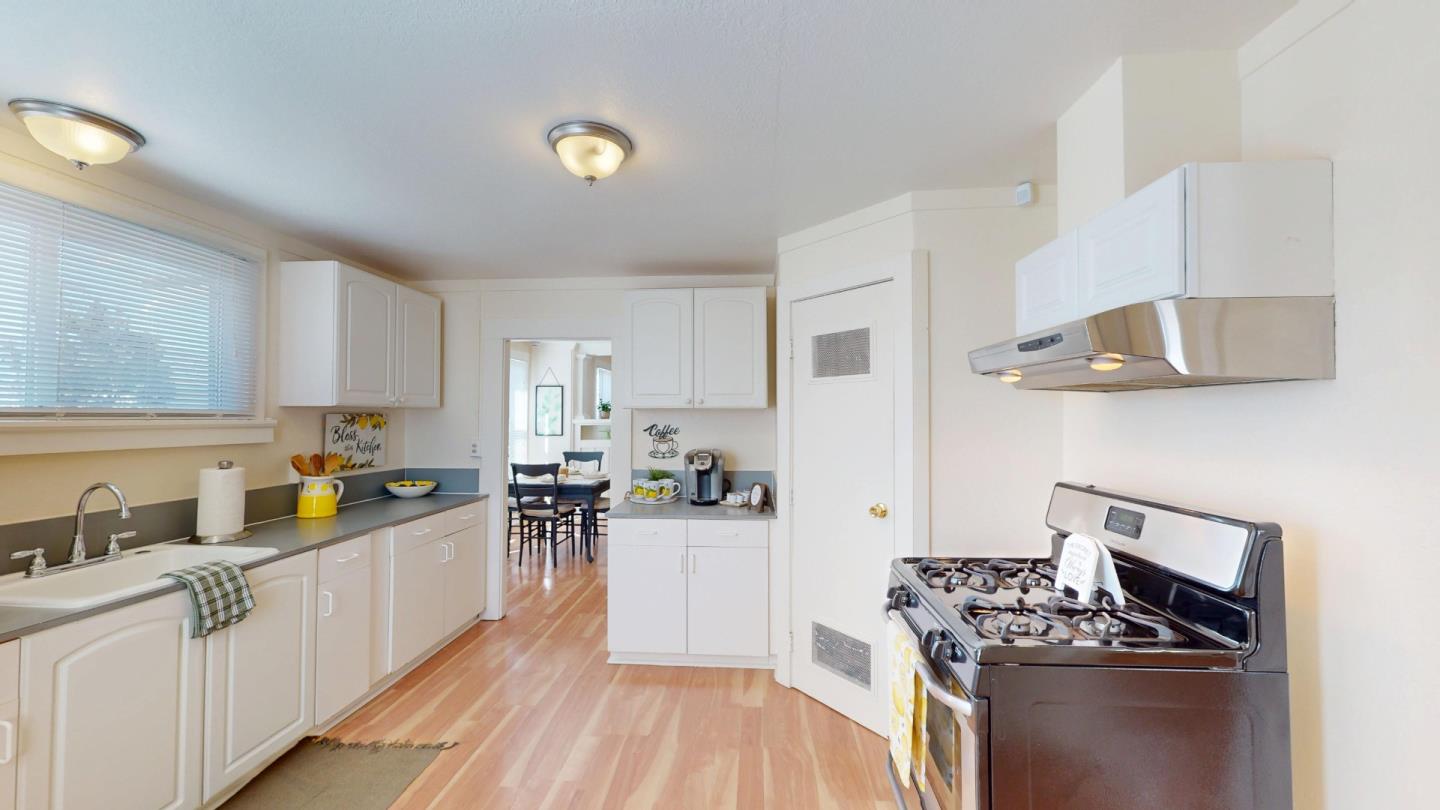 236 West Street Soledad, CA 93960 - Photo 16 of 41 a kitchen with stainless steel appliances a sink dishwasher stove refrigerator and cabinets with wooden floor