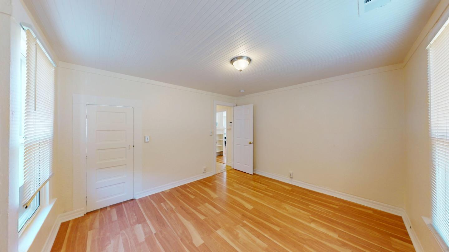 236 West Street Soledad, CA 93960 - Photo 24 of 41 an empty room with wooden floor and windows