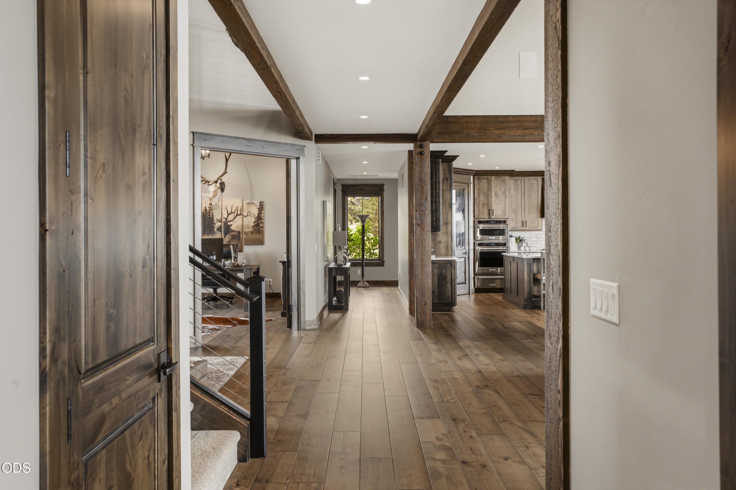 15935 South W Brasada Ranch Road Powell Butte, OR 97753 - Photo 22 of 45 a view of a hallway with wooden floor living room and dining room