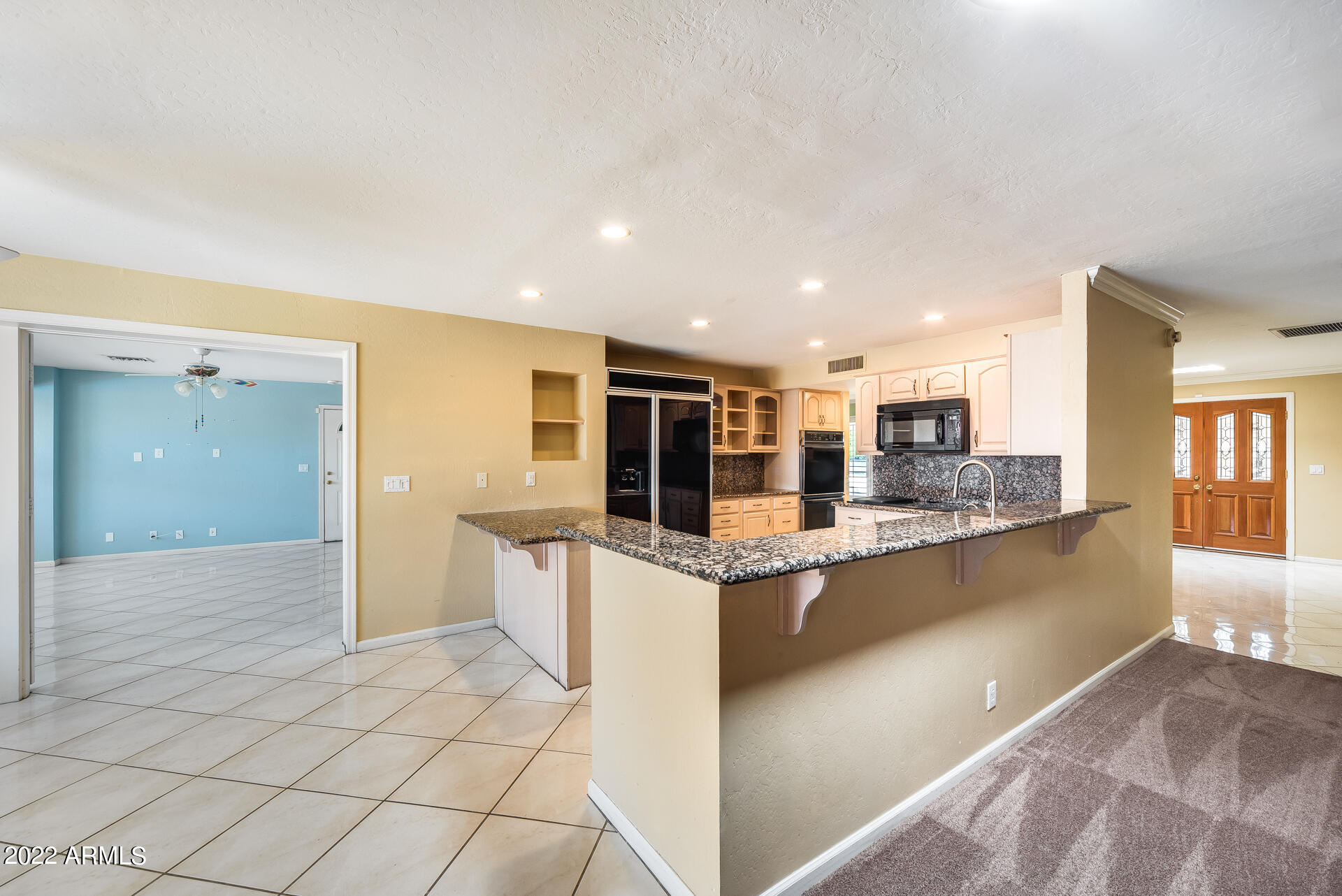 5501 East Camelback Road Phoenix, AZ 85018 - Photo 11 of 53 a large kitchen with stainless steel appliances kitchen island granite countertop a large counter top and oven