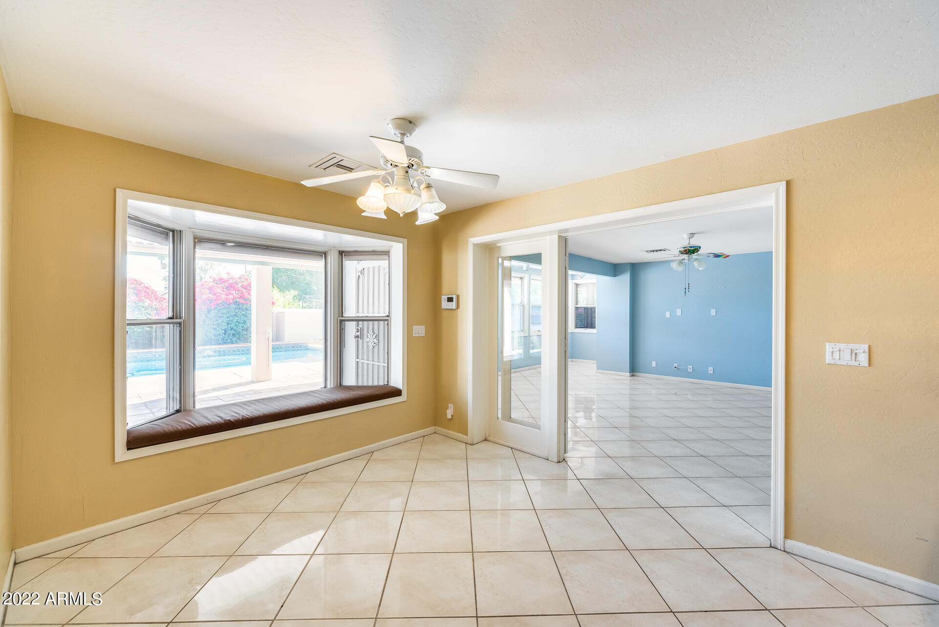 5501 East Camelback Road Phoenix, AZ 85018 - Photo 13 of 53 a view of an empty room with window and chandelier fan