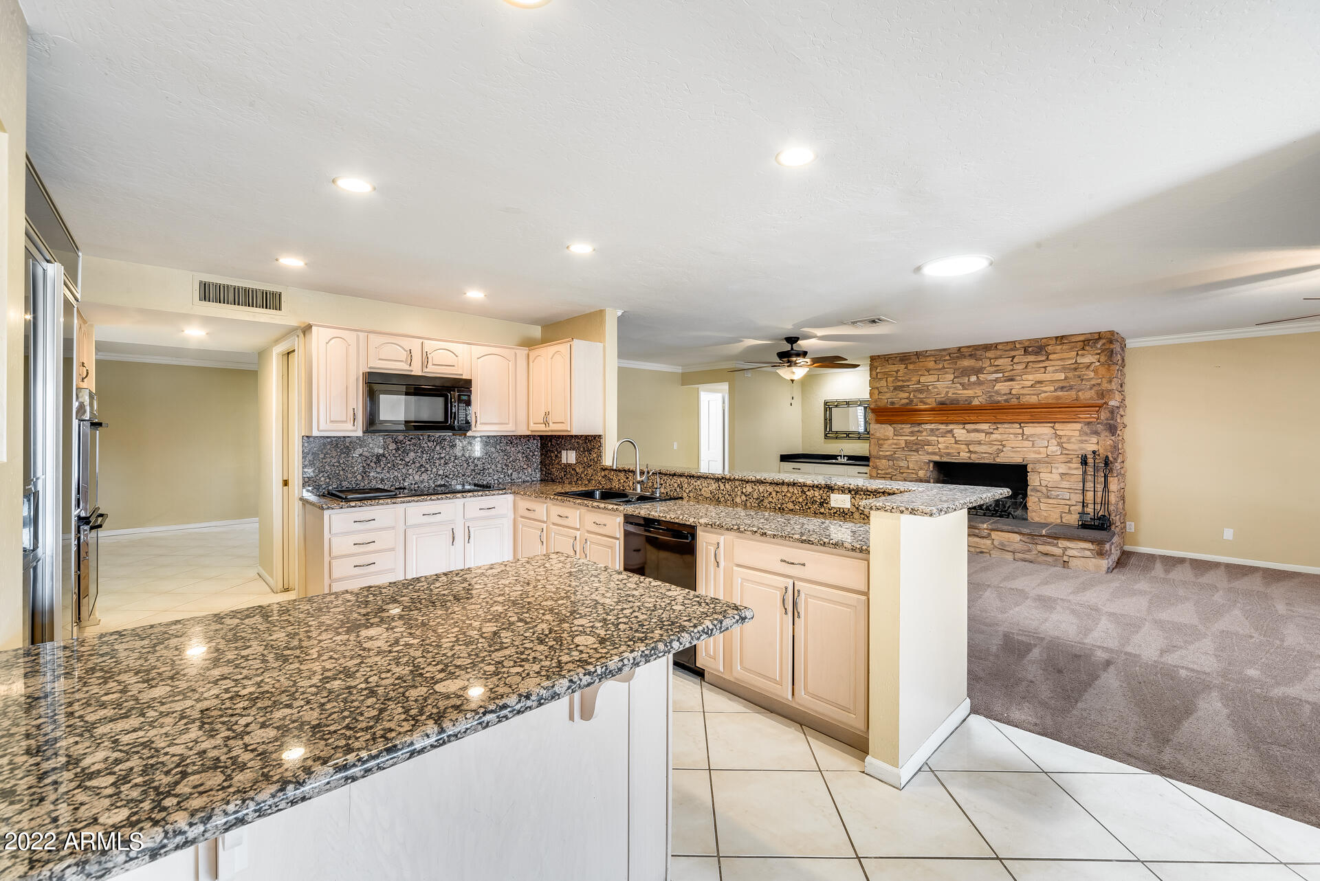 5501 East Camelback Road Phoenix, AZ 85018 - Photo 15 of 53 a large kitchen with stainless steel appliances kitchen island granite countertop a sink and cabinets