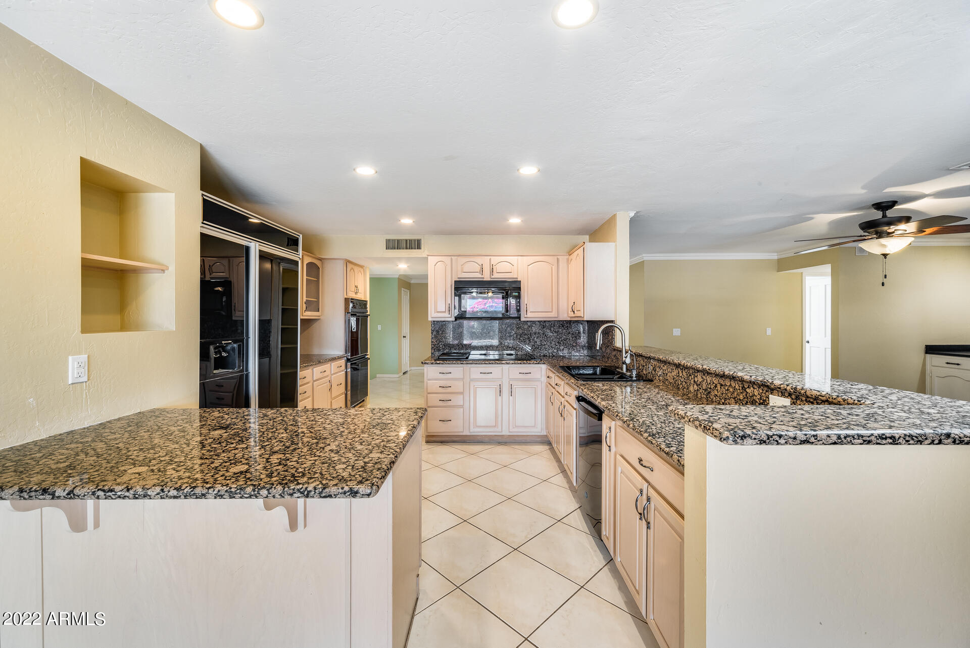 5501 East Camelback Road Phoenix, AZ 85018 - Photo 19 of 53 a large kitchen with kitchen island a sink stainless steel appliances and cabinets
