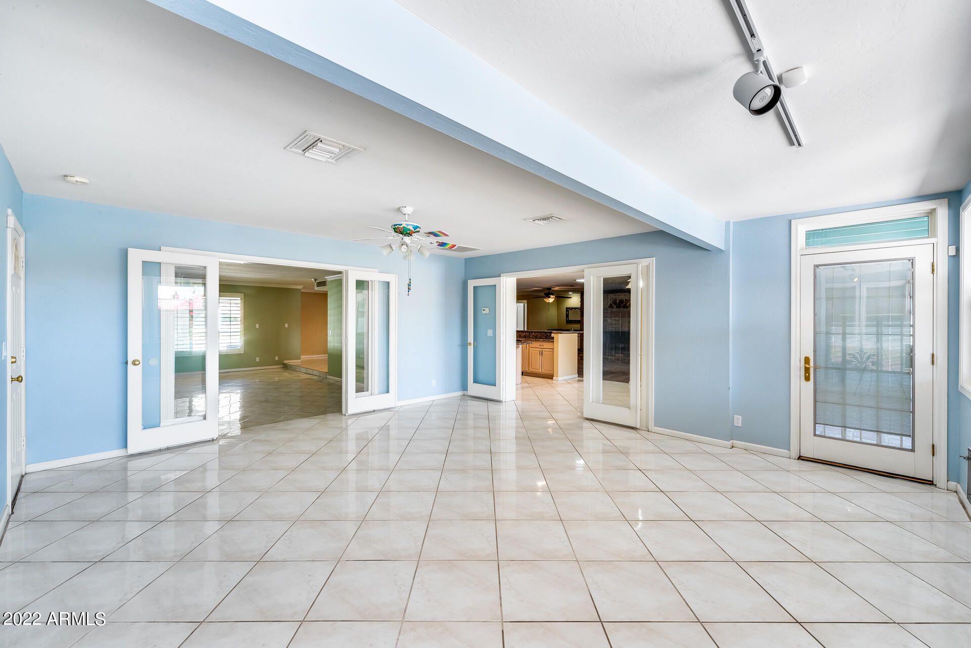 5501 East Camelback Road Phoenix, AZ 85018 - Photo 23 of 53 a view of a hallway with wooden floor and a dining room
