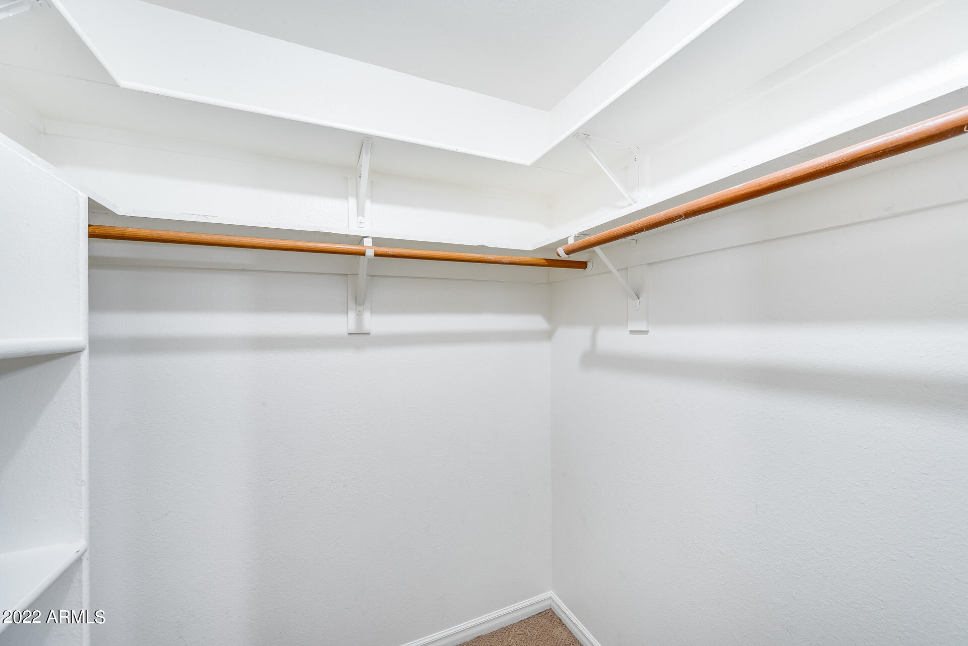 5501 East Camelback Road Phoenix, AZ 85018 - Photo 26 of 53 a room with a walk in closet and wooden floor