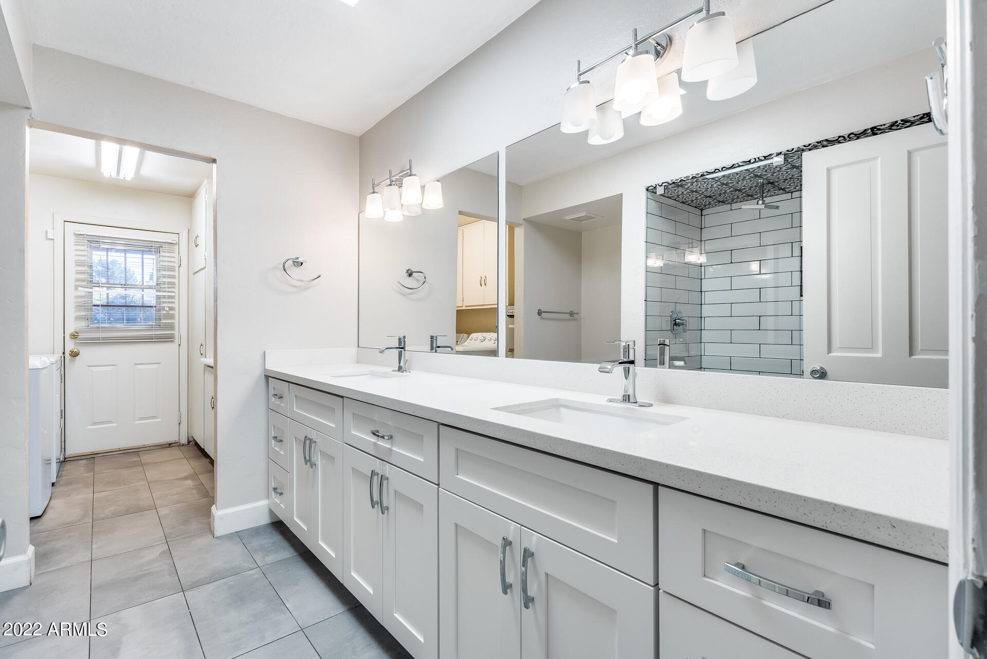 5501 East Camelback Road Phoenix, AZ 85018 - Photo 28 of 53 a spacious bathroom with a granite countertop sink a mirror and a shower