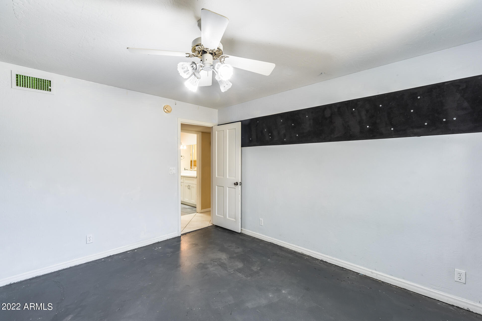 5501 East Camelback Road Phoenix, AZ 85018 - Photo 32 of 53 an empty room with a ceiling fan and wooden floor