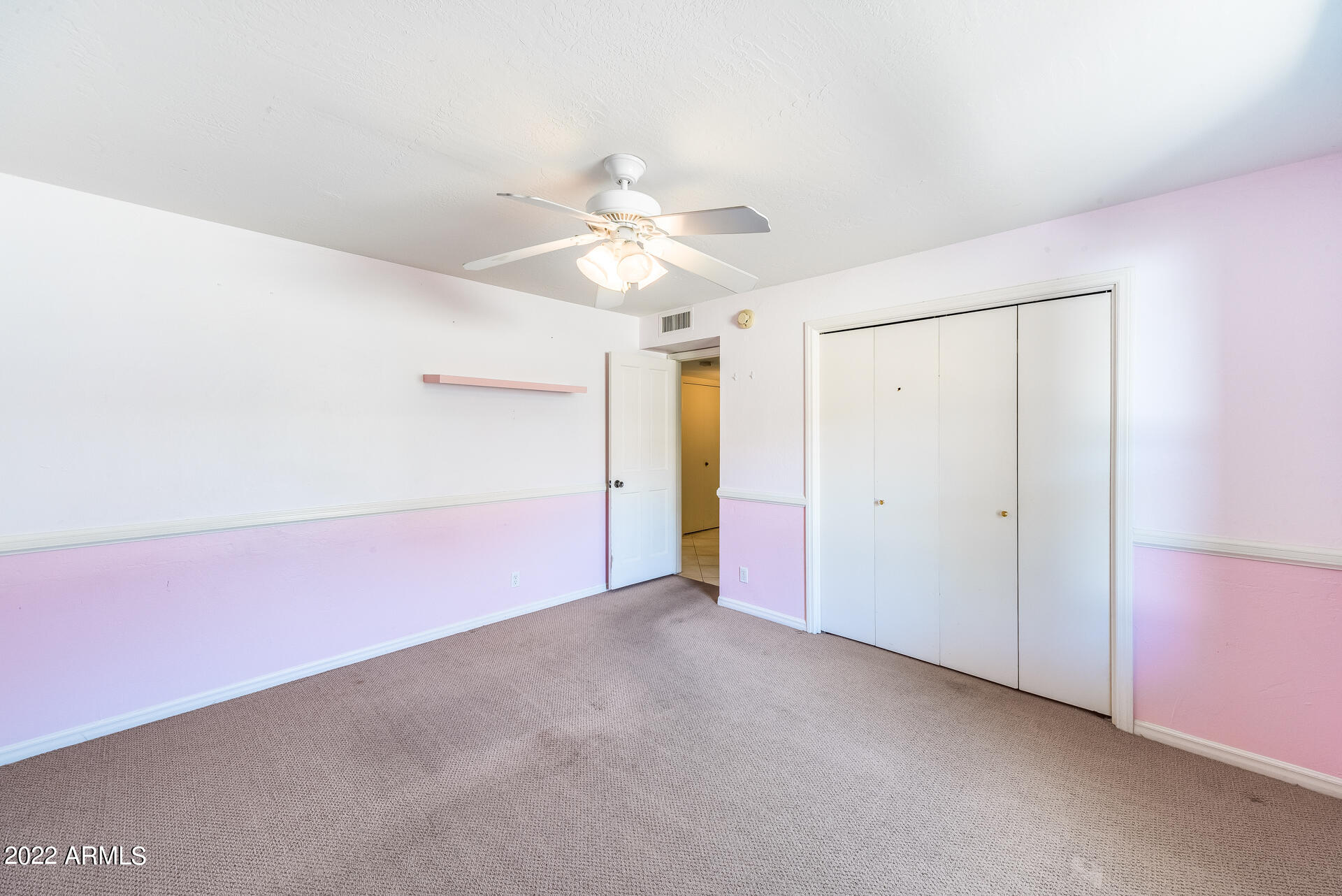 5501 East Camelback Road Phoenix, AZ 85018 - Photo 34 of 53 an empty room with a ceiling fan and a window