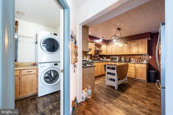 a bathroom with a granite countertop sink a mirror and shower