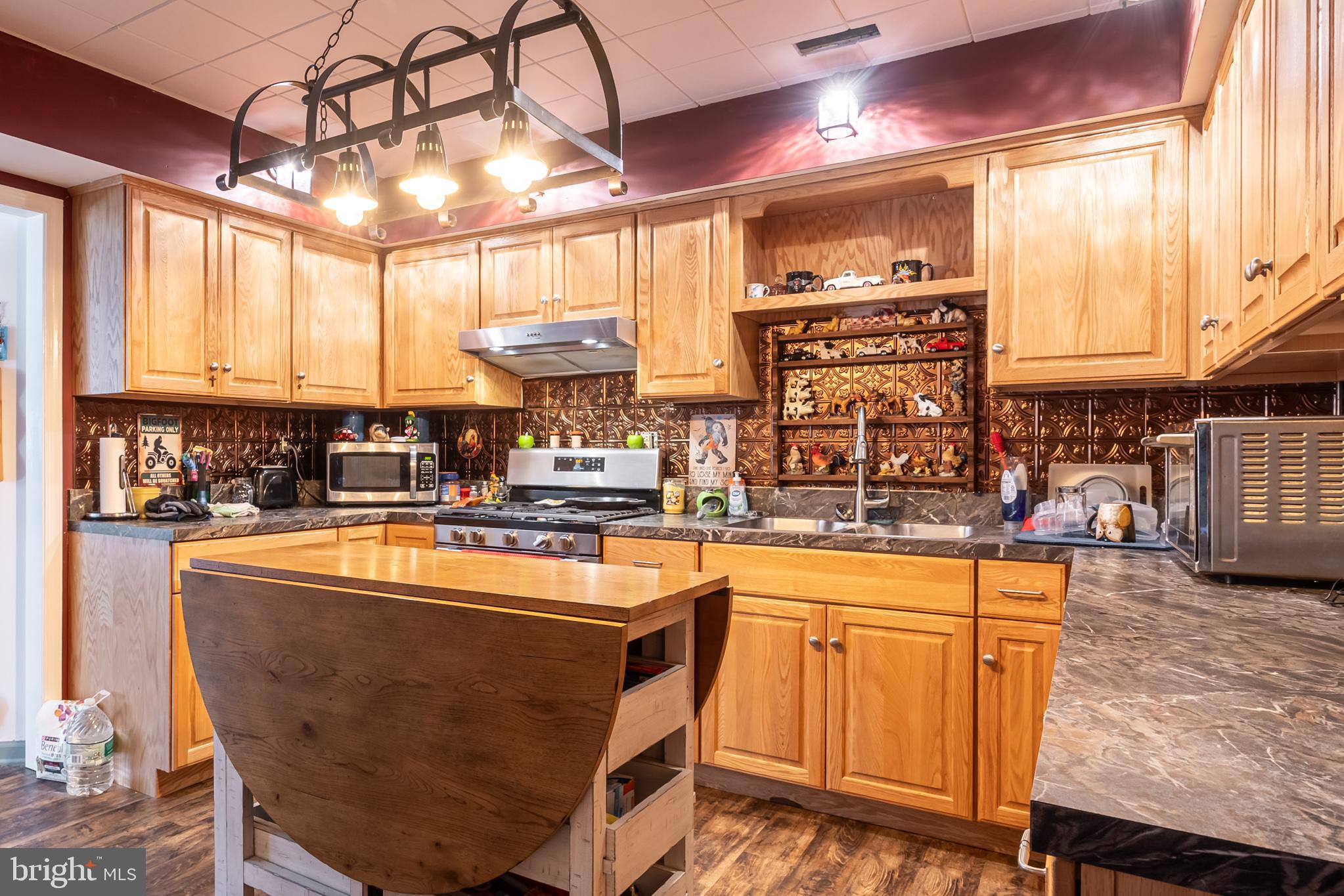 165 Brokenback Mountain Road Free Union, VA 22940 - Photo 31 of 71 a kitchen with stainless steel appliances granite countertop a sink a stove and a refrigerator