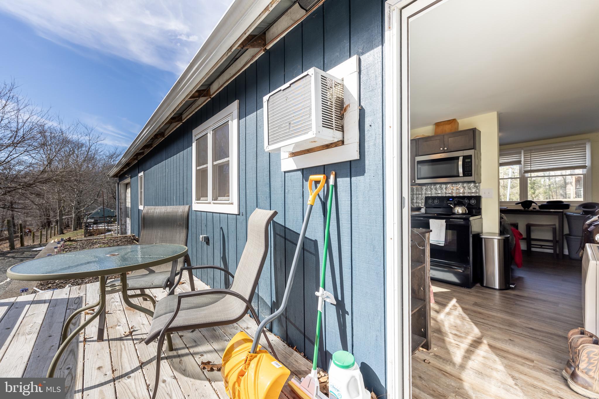 165 Brokenback Mountain Road Free Union, VA 22940 - Photo 55 of 71 a view of a patio with table and chairs and wooden floor