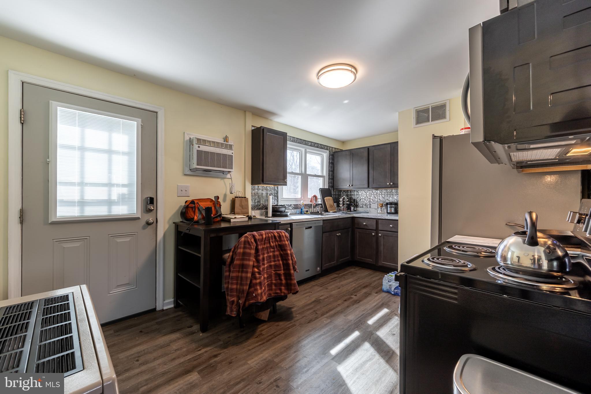 165 Brokenback Mountain Road Free Union, VA 22940 - Photo 57 of 71 a kitchen with a refrigerator wooden floor and a sink