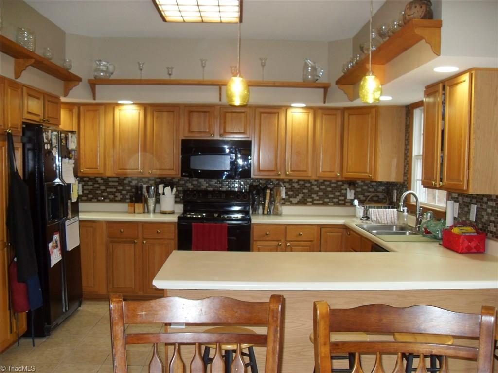 338 Fox Run View Lane Trinity, NC 27370 - Photo 5 of 21 Wonderful kitchen with lots of cabinets, bar, pendant lighting and new tile backsplash