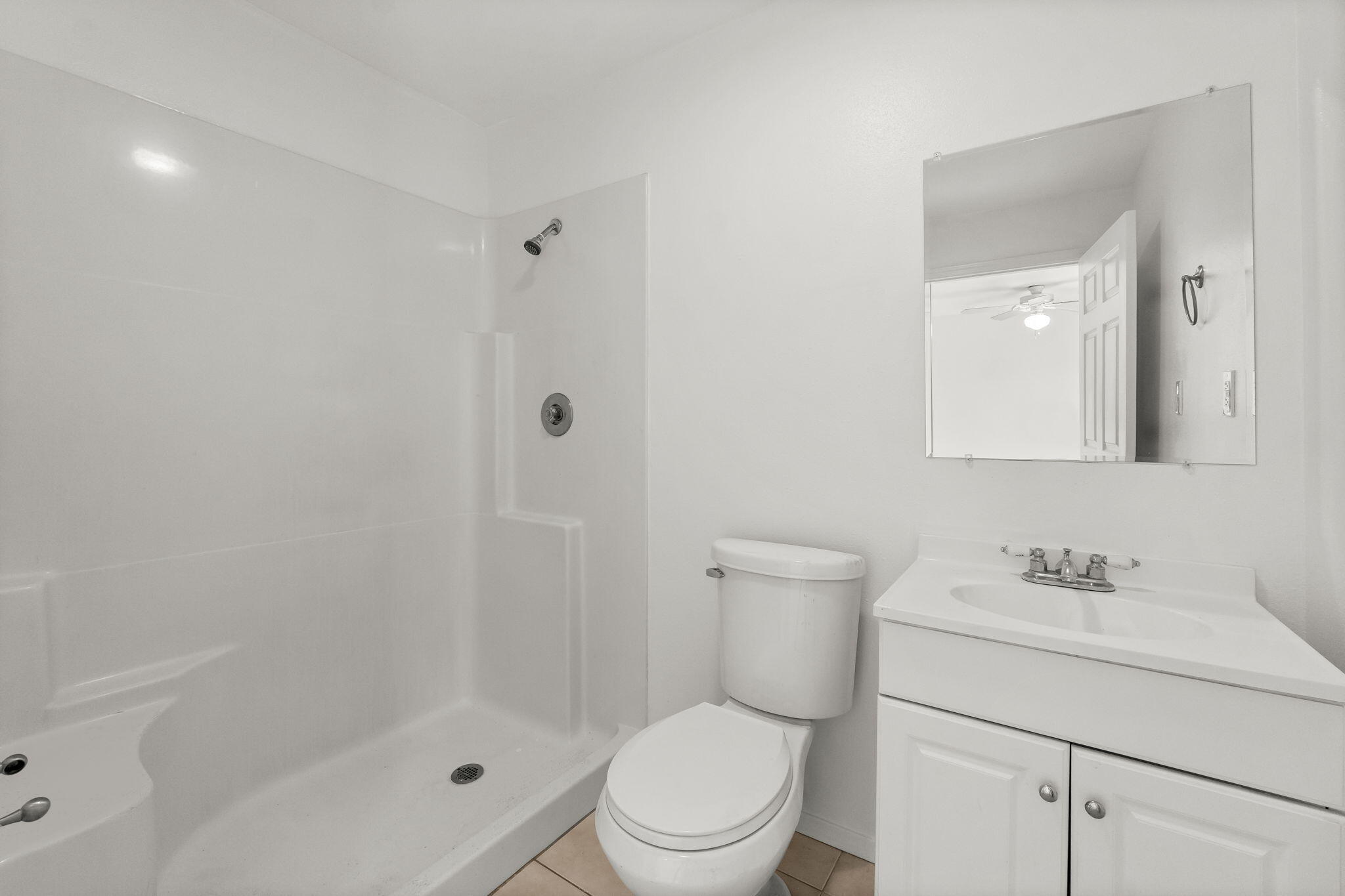 133 Sunrise Circle, Unit B Santa Rosa Beach, FL 32459 - Photo 14 of 25 a white toilet sitting next to a bathroom sink