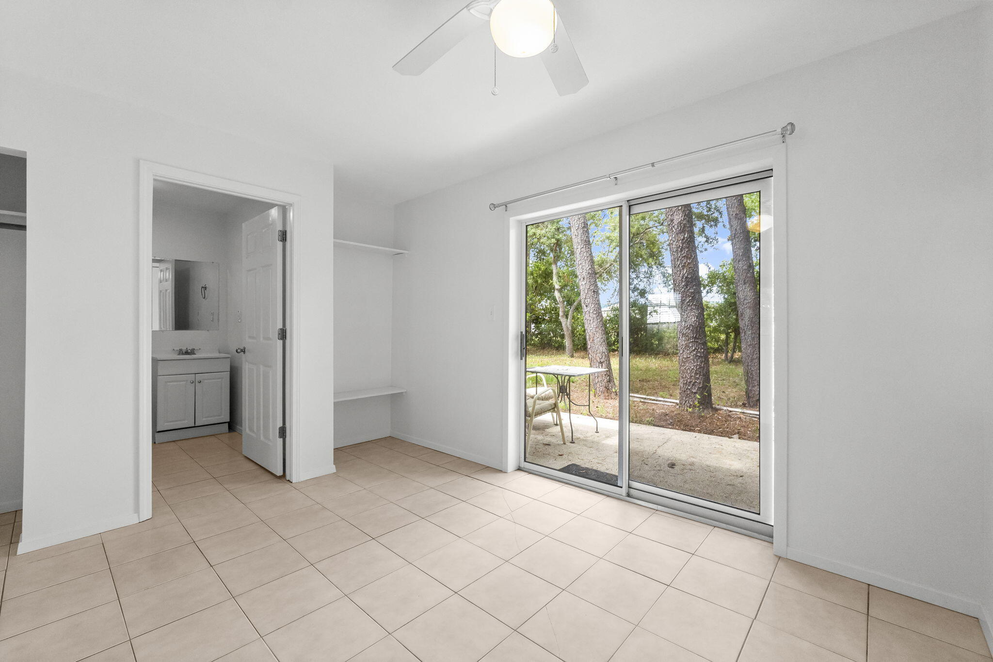 133 Sunrise Circle, Unit B Santa Rosa Beach, FL 32459 - Photo 16 of 25 a view of a room with sliding glass door and chandelier