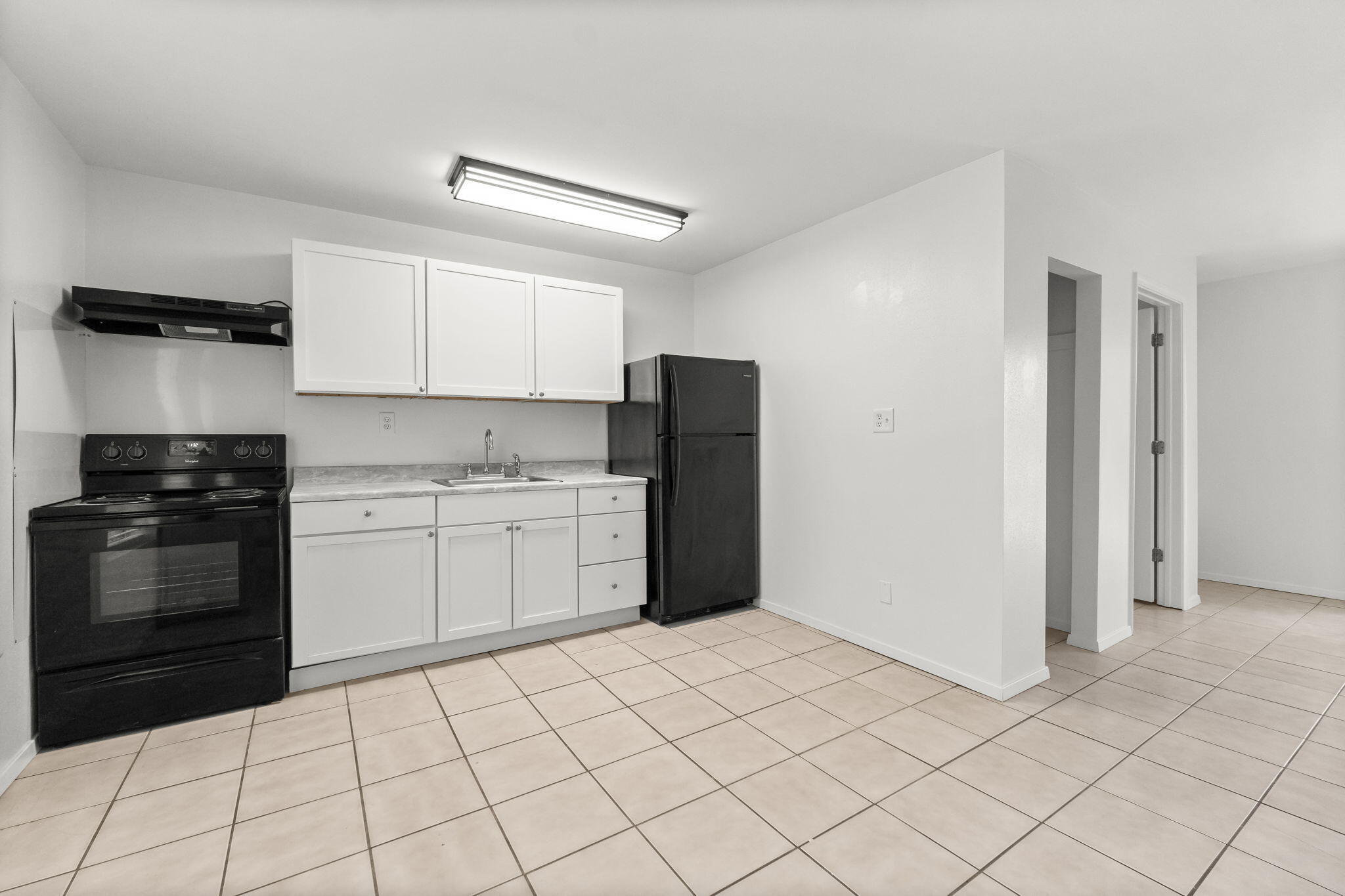 133 Sunrise Circle, Unit B Santa Rosa Beach, FL 32459 - Photo 7 of 25 a kitchen with a refrigerator sink and cabinets