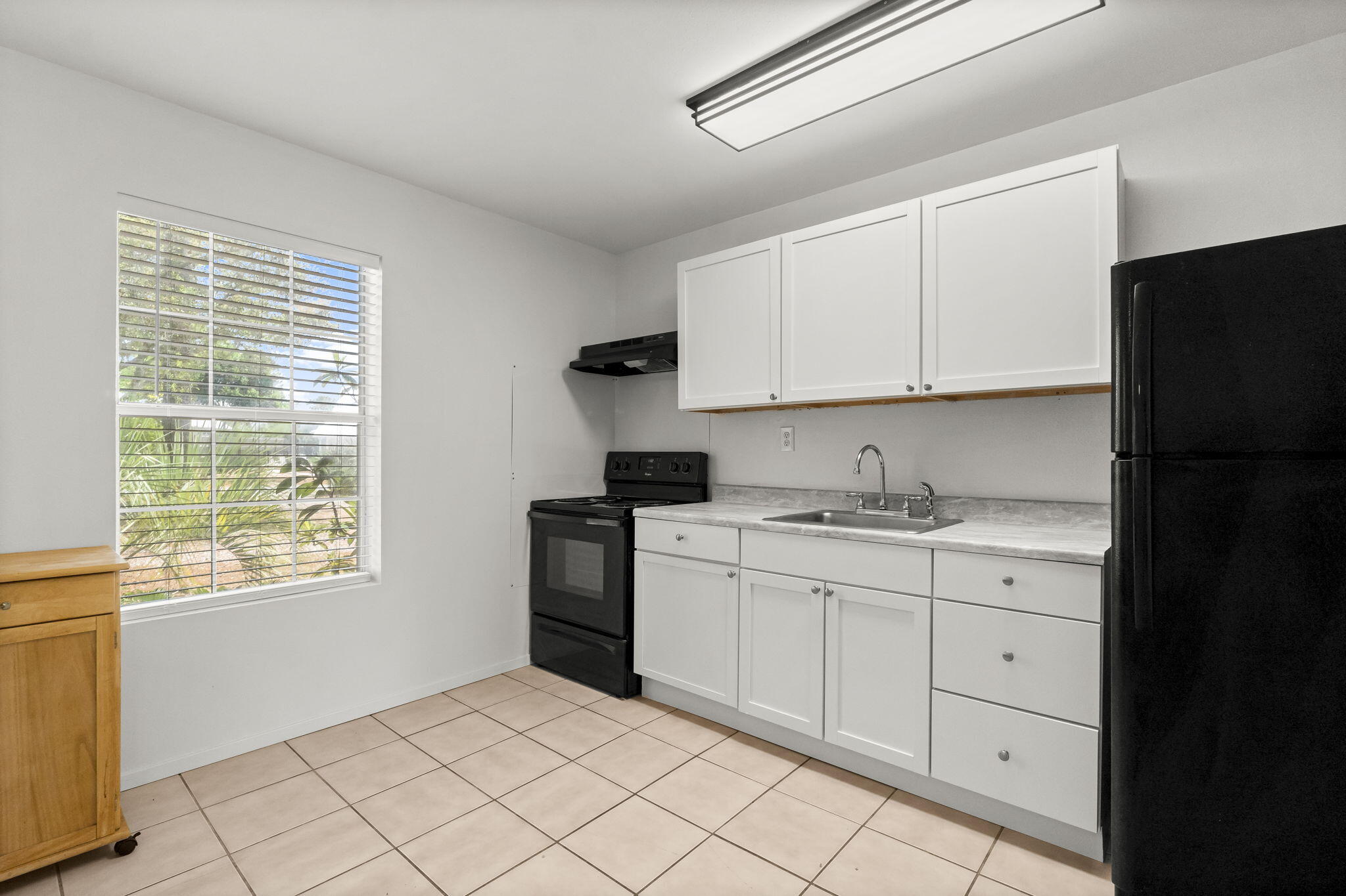 133 Sunrise Circle, Unit B Santa Rosa Beach, FL 32459 - Photo 8 of 25 a kitchen with granite countertop white cabinets and refrigerator