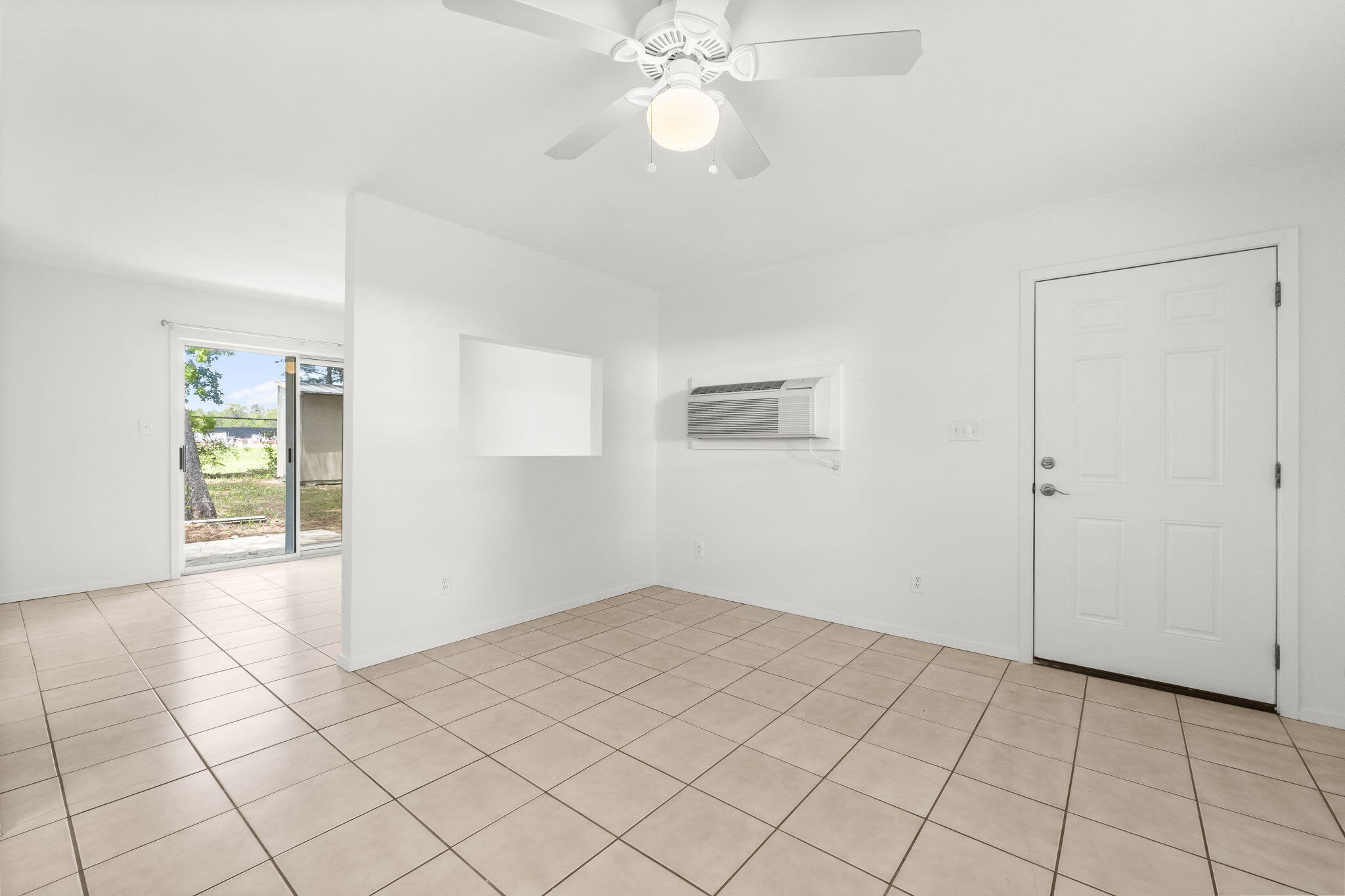 133 Sunrise Circle, Unit B Santa Rosa Beach, FL 32459 - Photo 10 of 25 a view of an empty room and window and chandelier fan