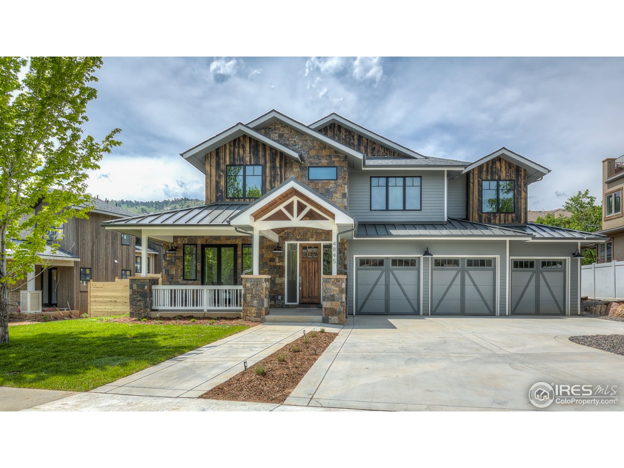 4845 6th Street Boulder, CO 80304 - Photo 1 of 25 a front view of a house with a yard