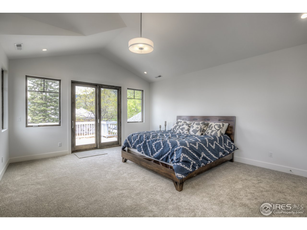 4845 6th Street Boulder, CO 80304 - Photo 13 of 25 a bed sitting in a spacious bedroom next to a window